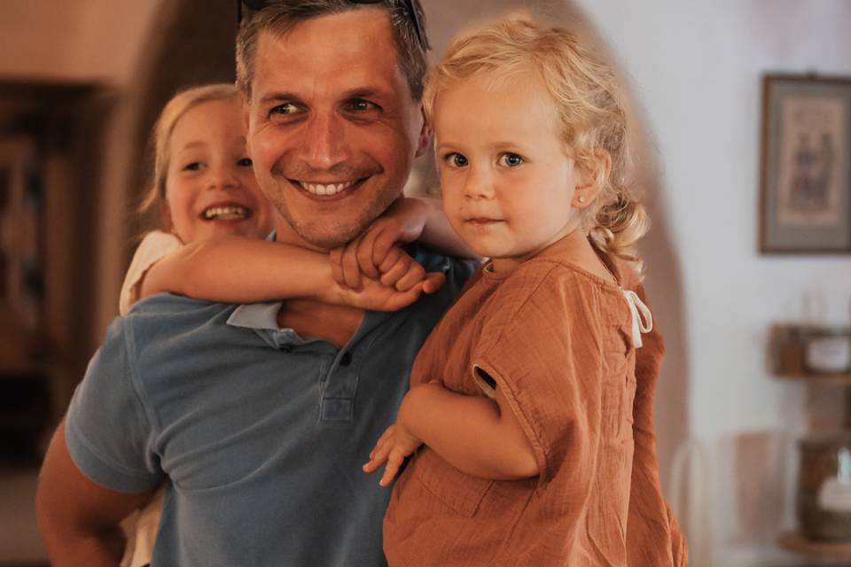 Dad holding two children in his arms.