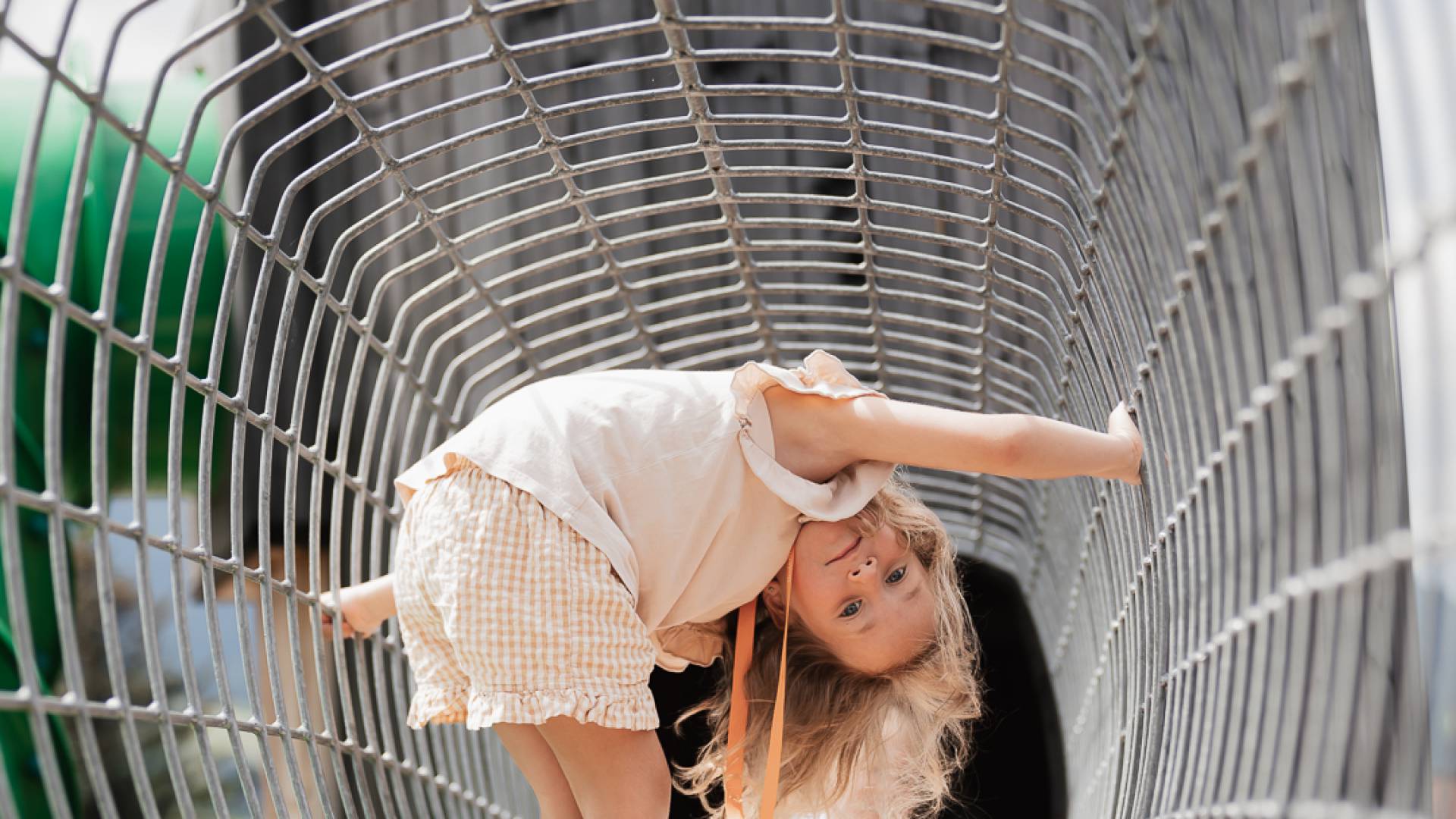 Girl playing on the outdoor playground at Tirolerhof.